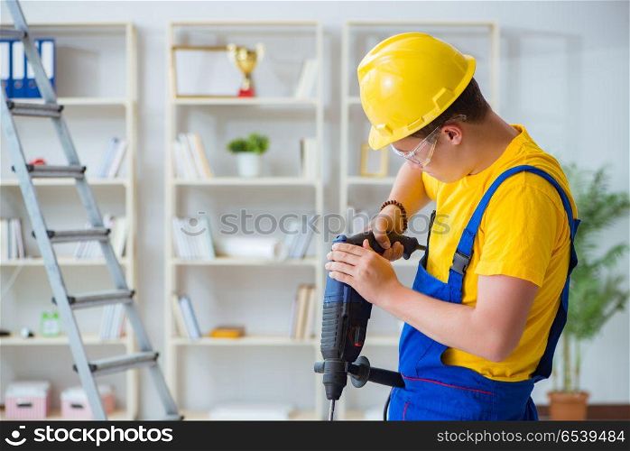 Young repairman with power drill