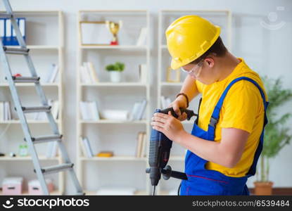 Young repairman with power drill