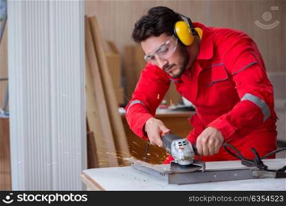 Young repairman working with a grinding wheel