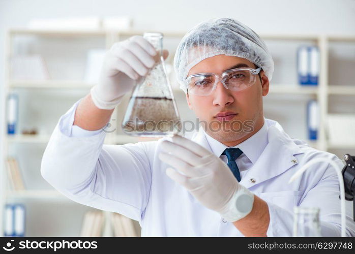 Young researcher scientist doing a water test contamination expe. Young researcher scientist doing a water test contamination experiment in the laboratory