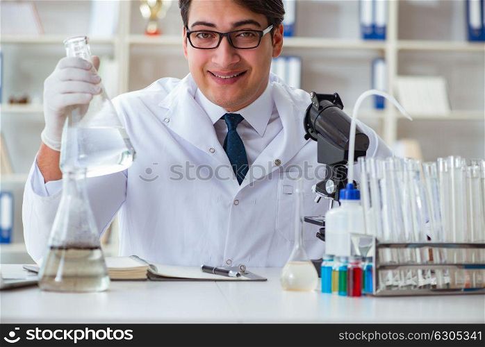 Young researcher scientist doing a water test contamination expe. Young researcher scientist doing a water test contamination experiment in the laboratory