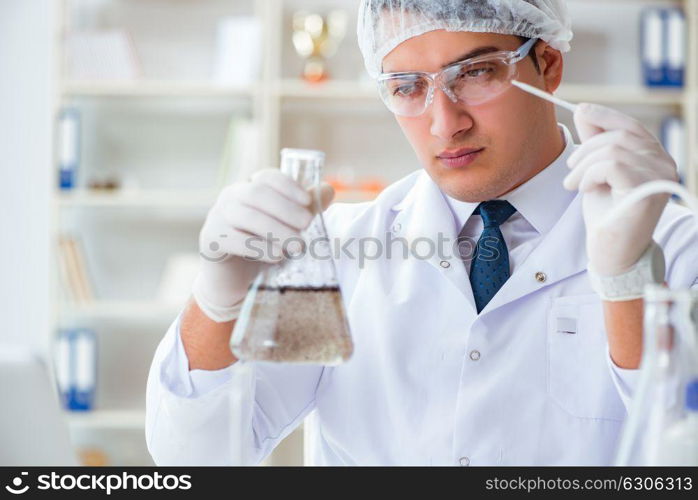 Young researcher scientist doing a water test contamination expe. Young researcher scientist doing a water test contamination experiment in the laboratory