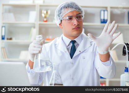 Young researcher scientist doing a water test contamination expe. Young researcher scientist doing a water test contamination experiment in the laboratory