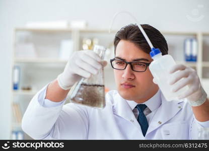 Young researcher scientist doing a water test contamination expe. Young researcher scientist doing a water test contamination experiment in the laboratory