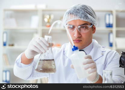 Young researcher scientist doing a water test contamination expe. Young researcher scientist doing a water test contamination experiment in the laboratory