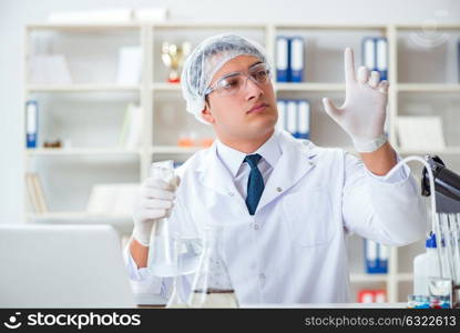 Young researcher scientist doing a water test contamination expe. Young researcher scientist doing a water test contamination experiment in the laboratory