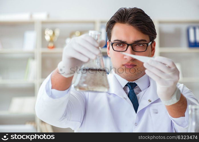 Young researcher scientist doing a water test contamination expe. Young researcher scientist doing a water test contamination experiment in the laboratory