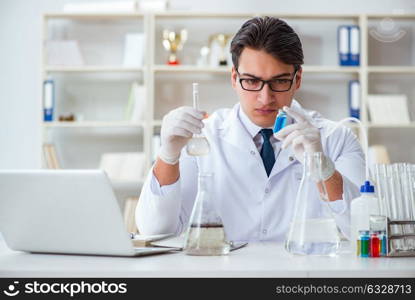 Young researcher scientist doing a water test contamination expe. Young researcher scientist doing a water test contamination experiment in the laboratory