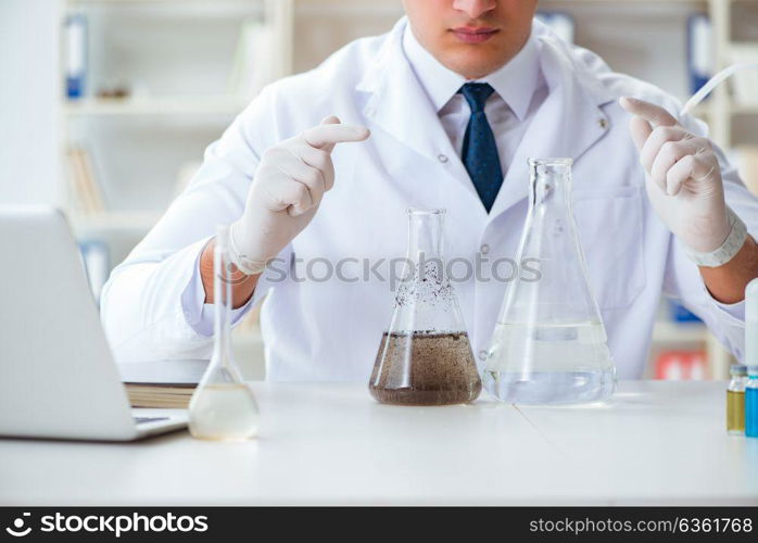 Young researcher scientist doing a water test contamination expe. Young researcher scientist doing a water test contamination experiment in the laboratory