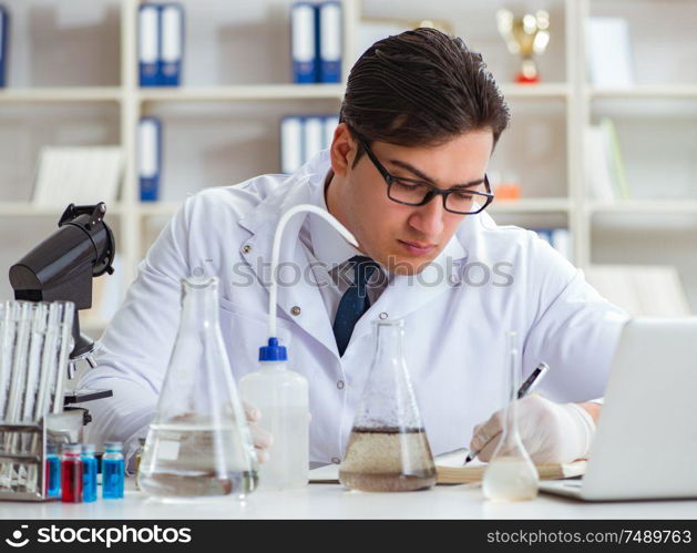 Young researcher scientist doing a water test contamination experiment in the laboratory. Young researcher scientist doing a water test contamination expe