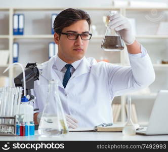 Young researcher scientist doing a water test contamination experiment in the laboratory. Young researcher scientist doing a water test contamination expe