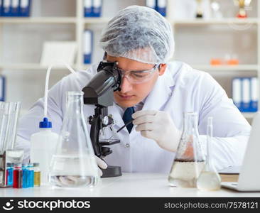 Young researcher scientist doing a water test contamination experiment in the laboratory. Young researcher scientist doing a water test contamination expe