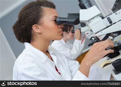 young researcher working with microscope in the lab