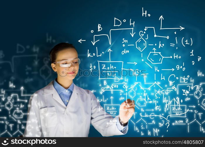 Young researcher. Young woman researcher in medical uniform drawing chemistry formulas