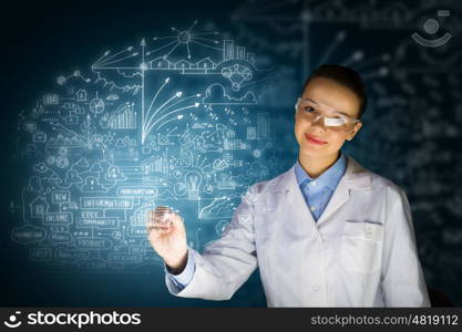 Young researcher. Young woman researcher in medical uniform drawing chemistry formulas