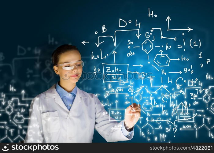 Young researcher. Young woman researcher in medical uniform drawing chemistry formulas