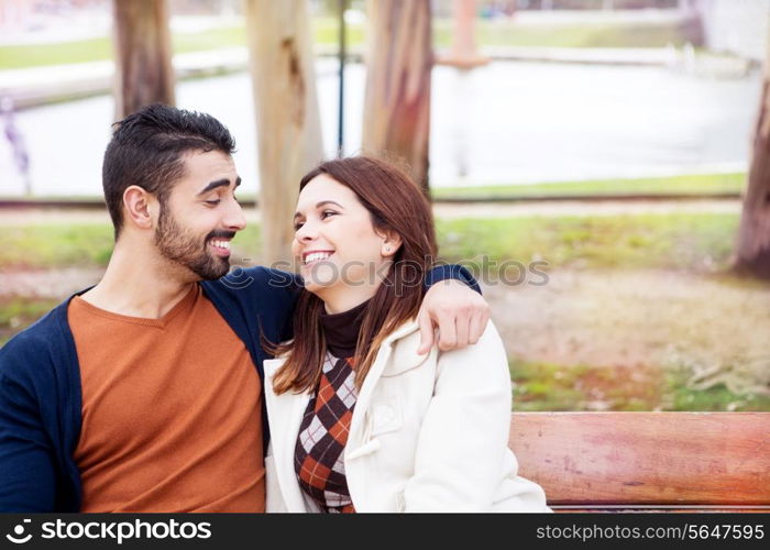 Young romantic couple on a bench in park