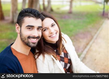 Young romantic couple on a bench in park