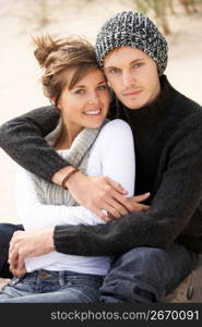 Young Romantic Couple Relaxing On Beach Together