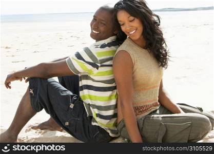 Young Romantic Couple Relaxing On Beach Together