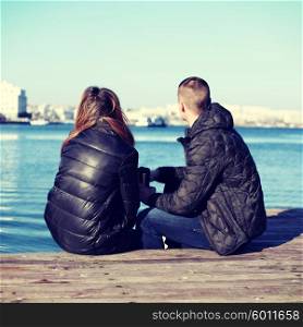 Young romantic couple sitting on the bay