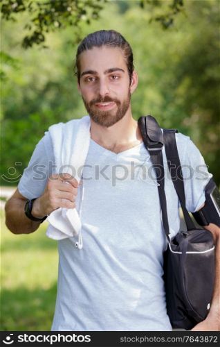 young runner taking breath after running in the park