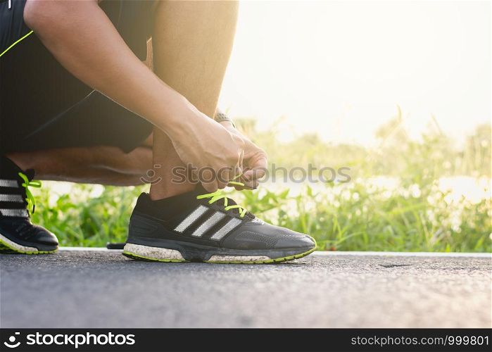 Young runner Tied the shoe laces on the runway.