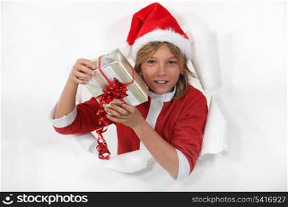 Young Santa Claus holding a gift