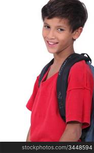 Young schoolboy wearing a large rucksack