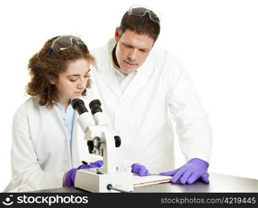 Young science student works in lab while professor supervises. Isolated on white.