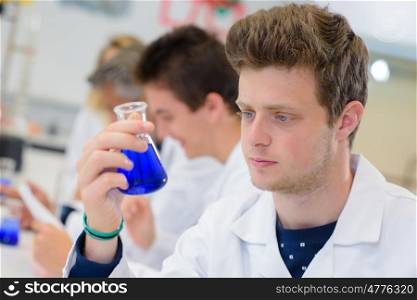 Young scientist holding ernlenmeyer flask