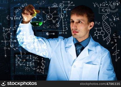 Young scientist in laboratory in white uniform