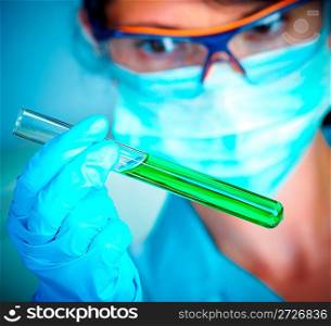 Young scientist in laboratory with test tubes
