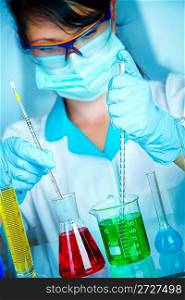Young scientist in laboratory with test tubes
