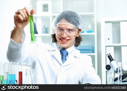 Young scientist in white uniform working in laboratory