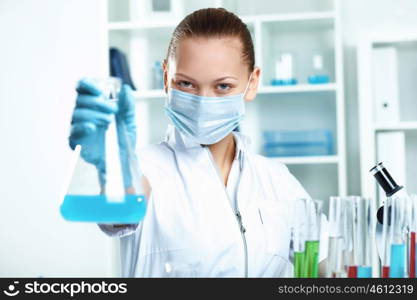 Young scientist in white uniform working in laboratory