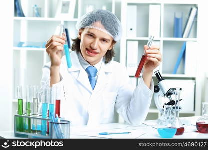 Young scientist in white uniform working in laboratory