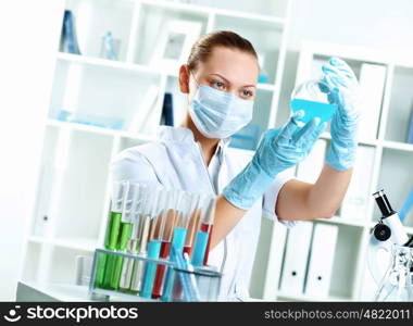 Young scientist in white uniform working in laboratory