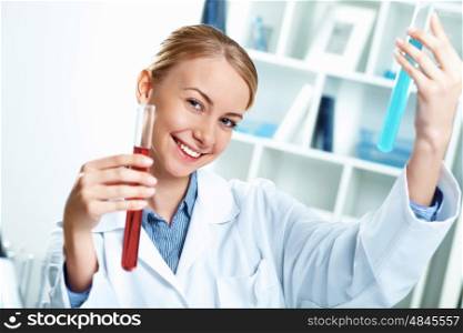 Young scientist in white uniform working in laboratory