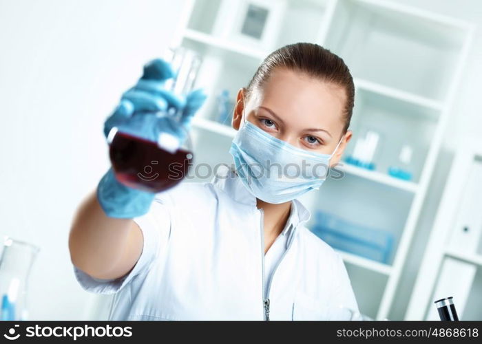 Young scientist in white uniform working in laboratory