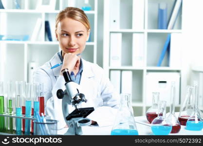 Young scientist in white uniform working in laboratory