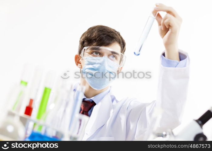 Young scientist making chemical tests in laboratory. In the name of science