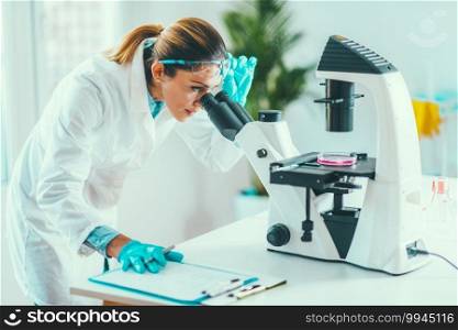 Young scientist working in her lab