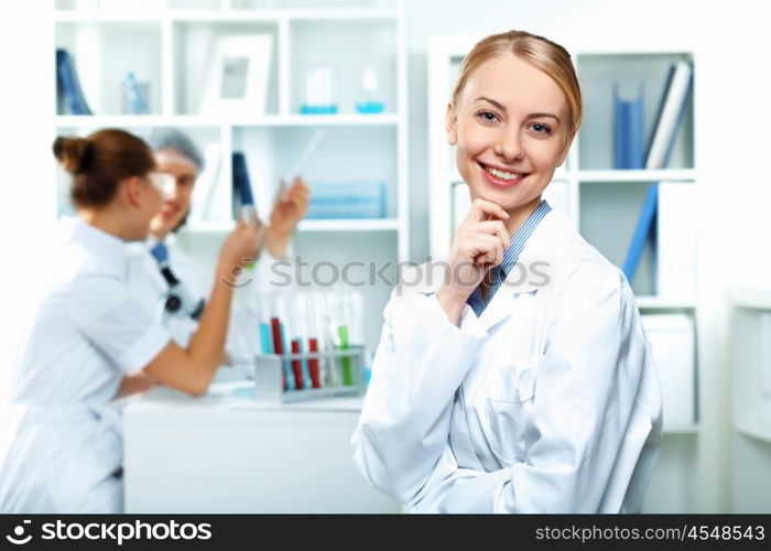 Young scientists in white uniform working in laboratory