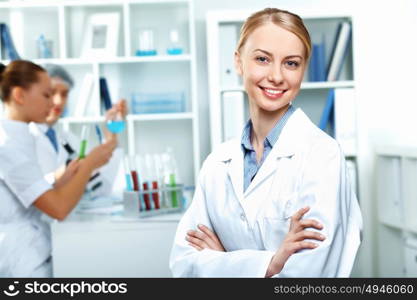 Young scientists in white uniform working in laboratory