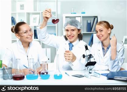 Young scientists in white uniform working in laboratory