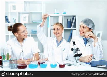 Young scientists in white uniform working in laboratory