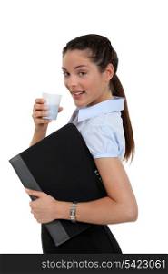 young secretary having cup of coffee