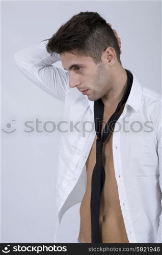 young sensual casual man portrait on a grey background