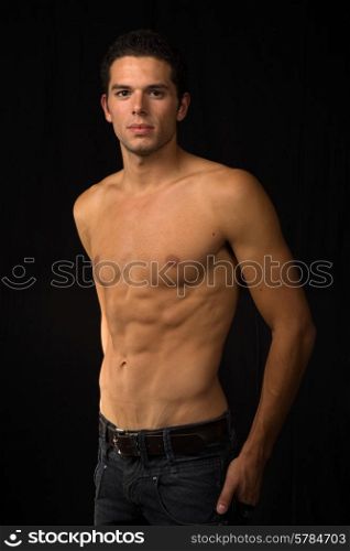young sensual man on a black background